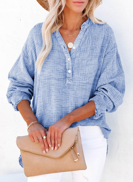 Women's basic V-neck pullover shirt in blue with button closures and rolled-up sleeves.